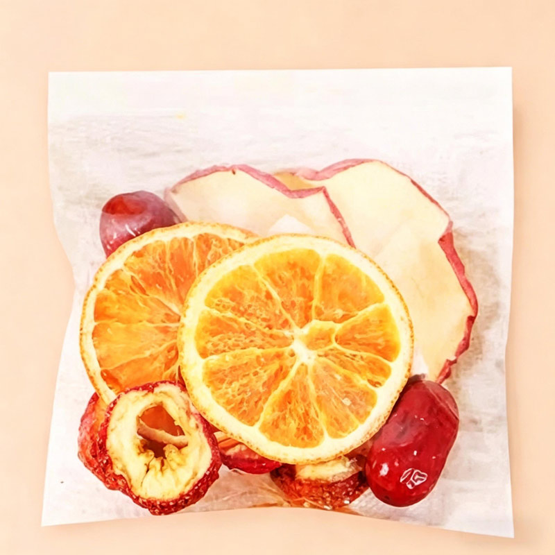 Single sachet dry mix of Apple & Poria Cocos tea with apple, orange and red date pieces